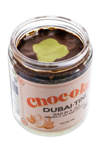 Jar of CHOCOLATA DubaiTini chocolate bar with milk, dark chocolate, and pistachio butter topped with phyllo dough.