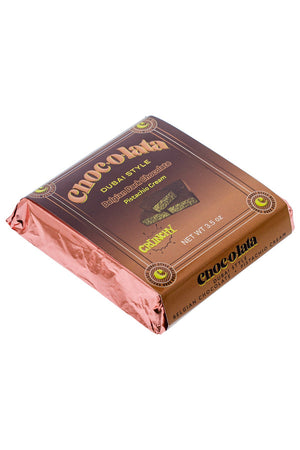 Side view of single bar of Chocolata Dubai Style Belgian Dark Chocolate with pistachio crunchy cream on white background
